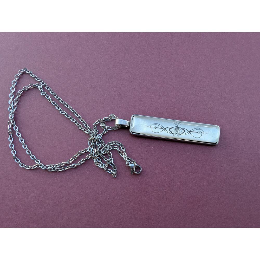 Scrollwork pendant necklace made with Knight and the Moth book pages